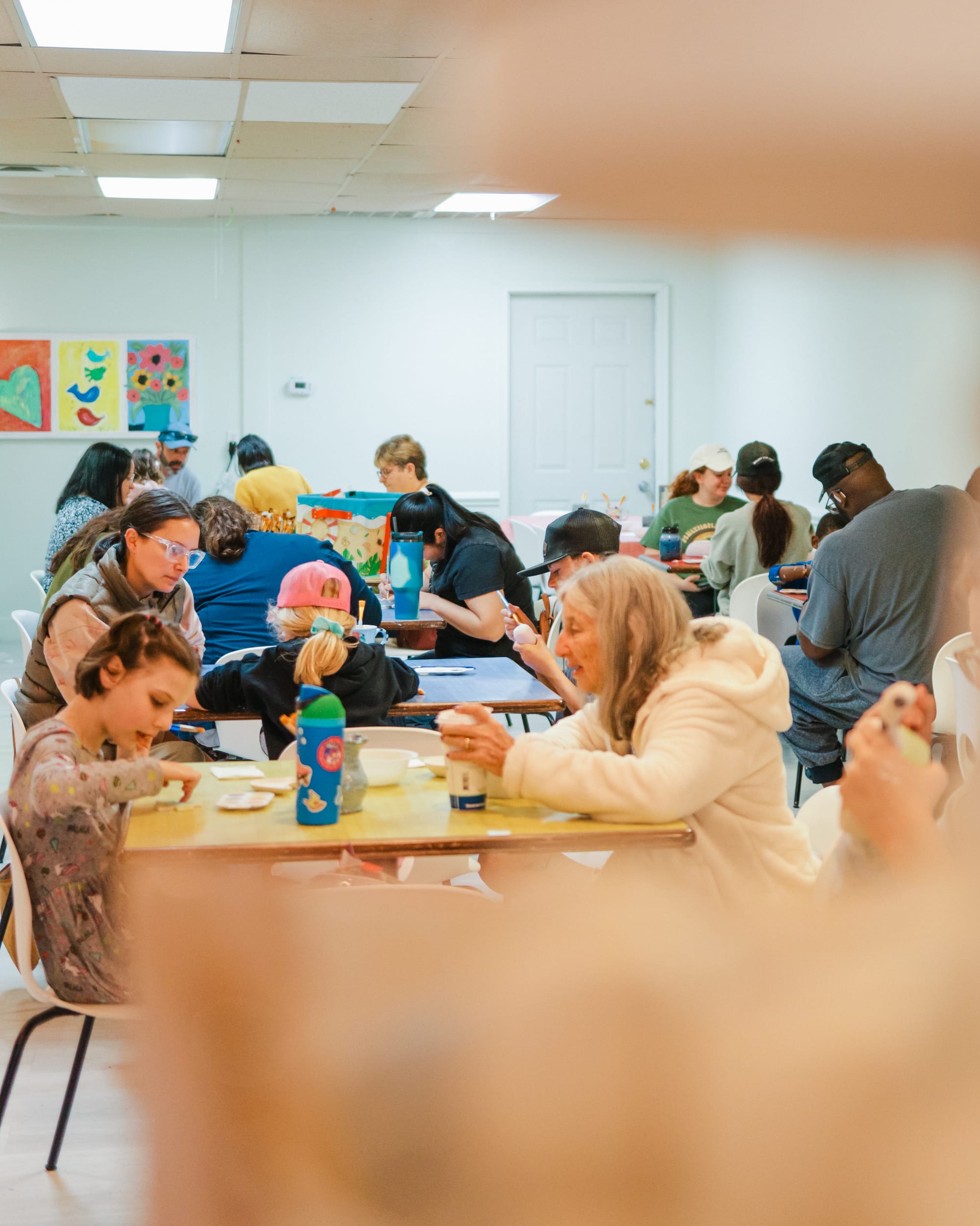 People painting pottery together