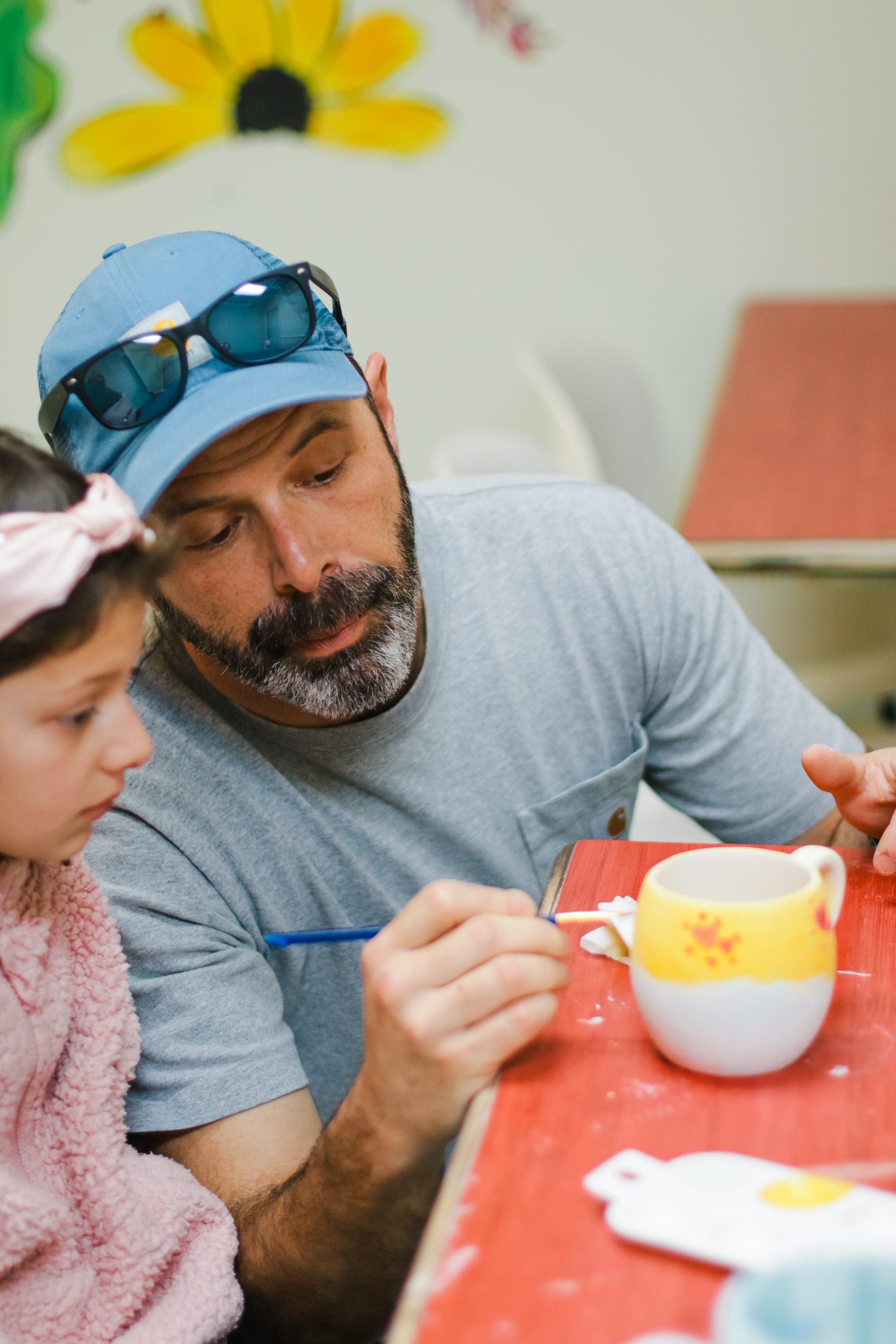 Father and daughter painting together
