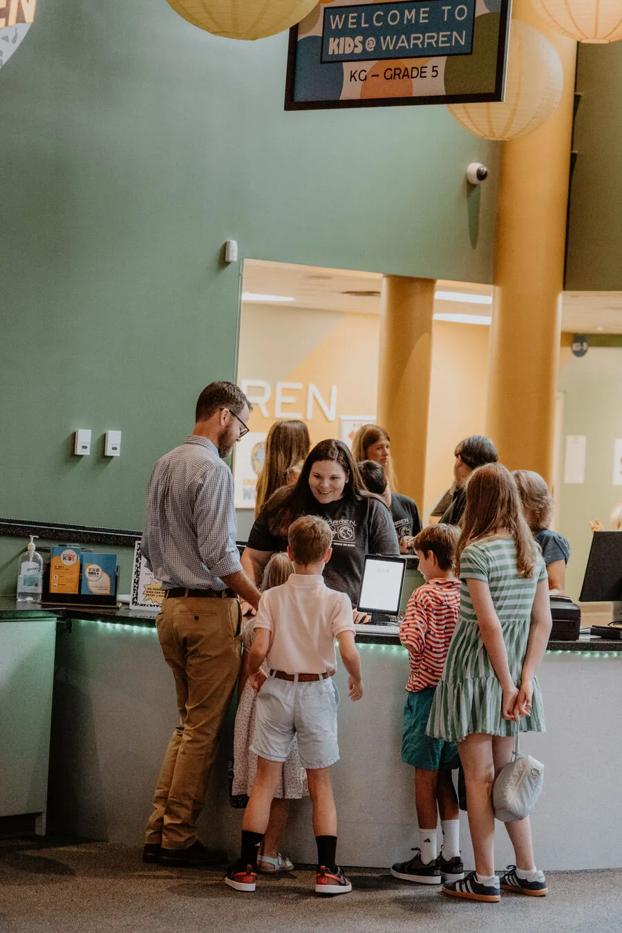 Families at the Kids@Warren check-in desk.