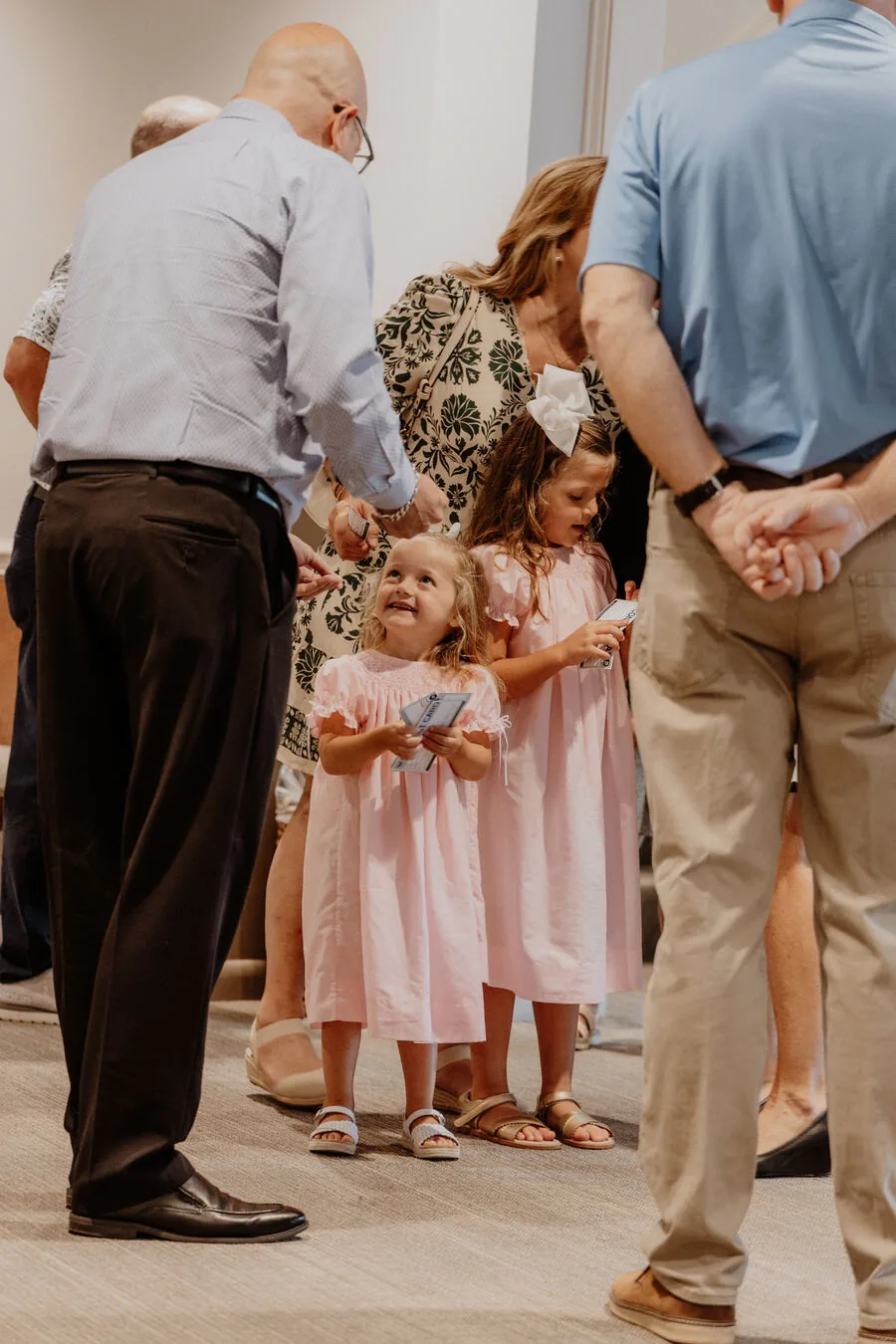 A family praying together at the front of the room.