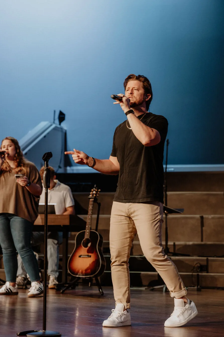 Leading a song from the stage.