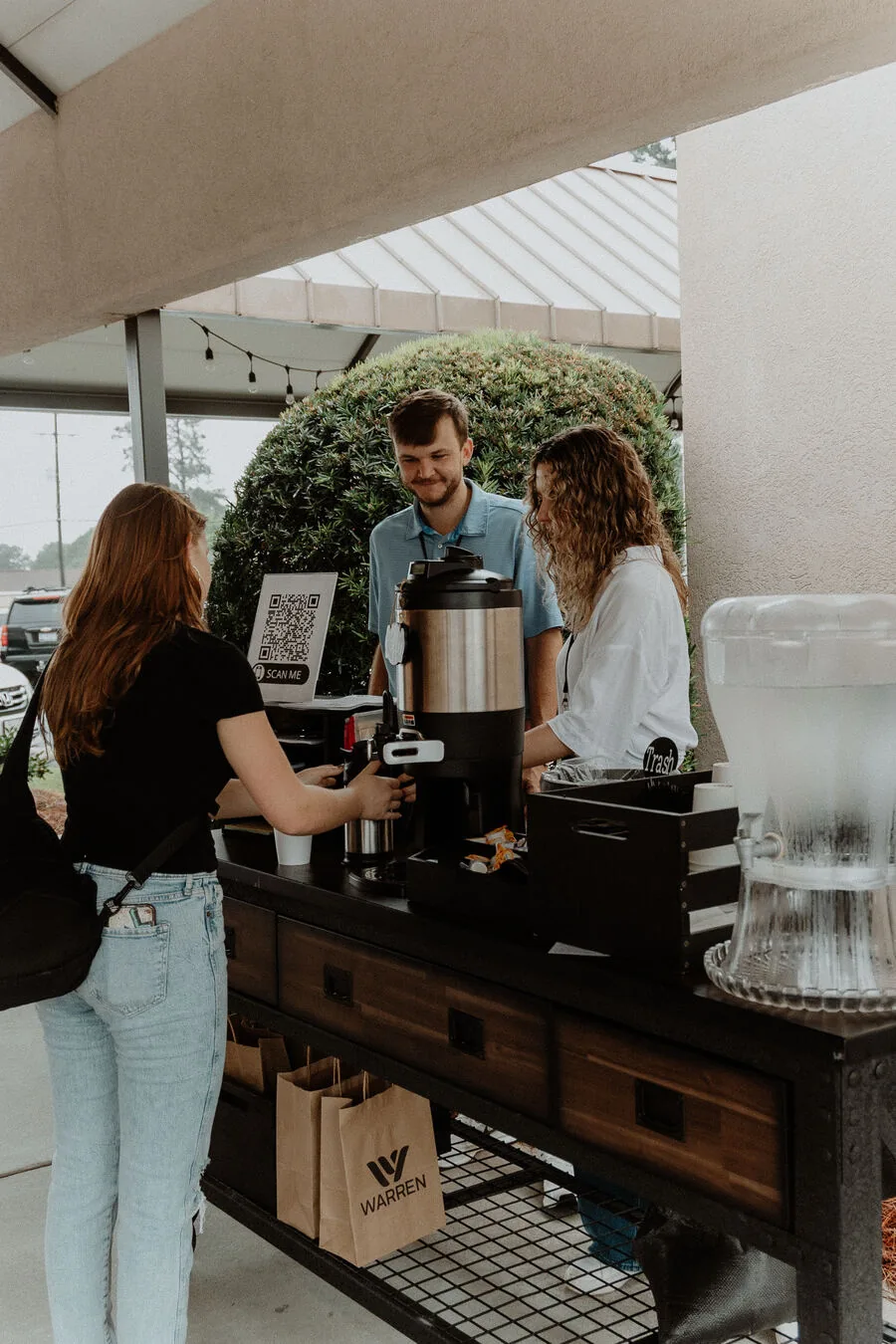 People at the coffee station before a service.