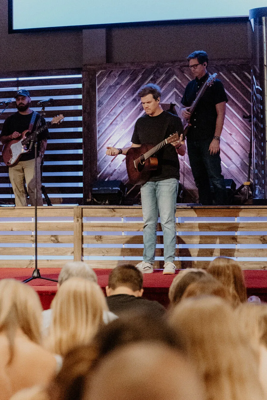 A guitarist leading a song from the stage.
