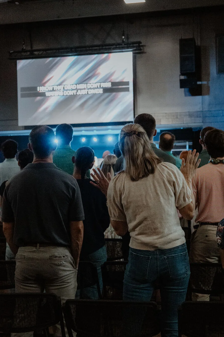 The room standing together during a service.