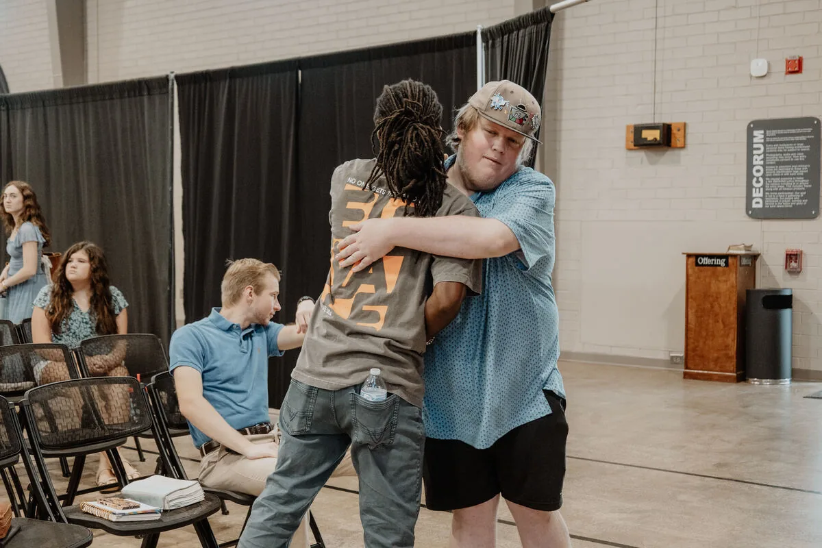 Two people hugging after a service.