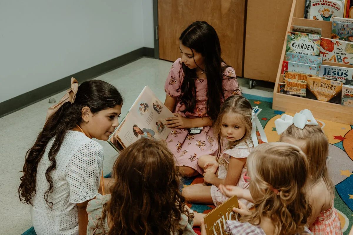 Children looking at books in the kids room.