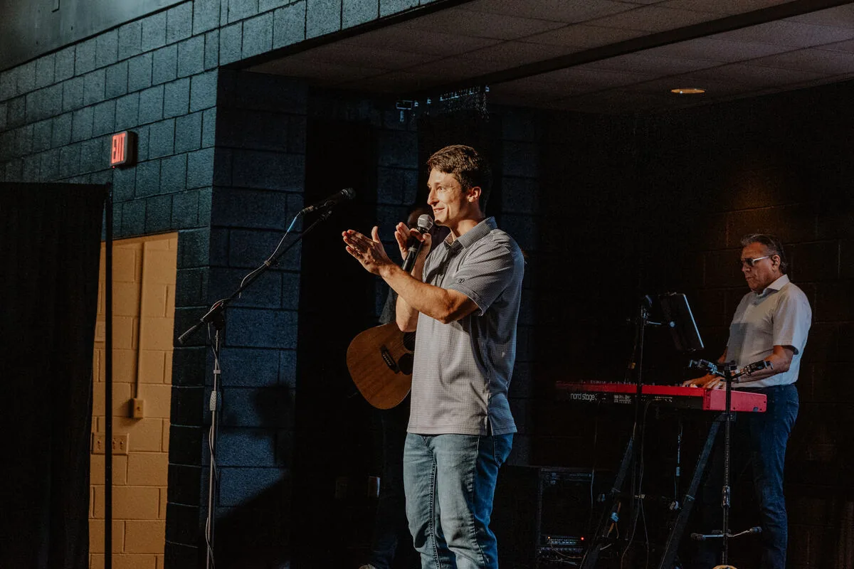Two musicians singing on stage.