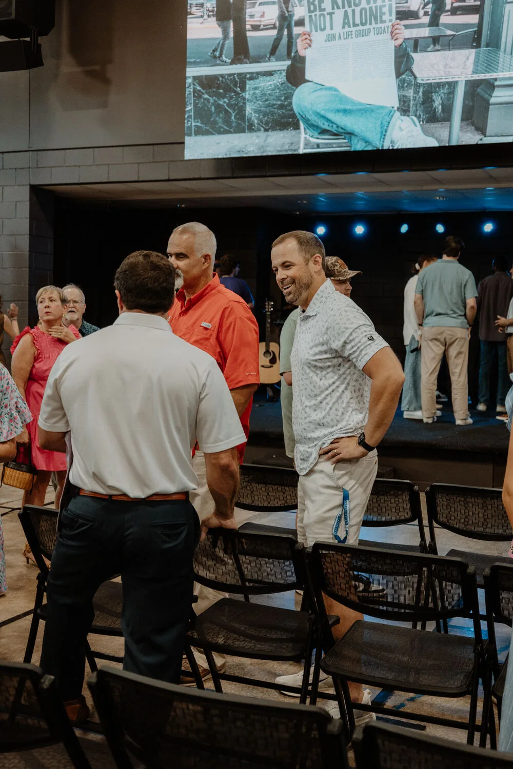 People standing and talking after a service.