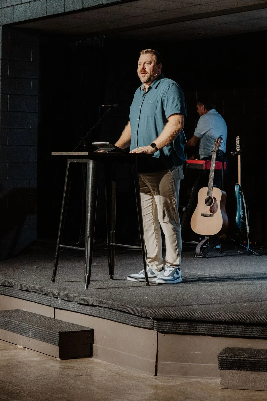 Teaching from a stand at the front of the room.
