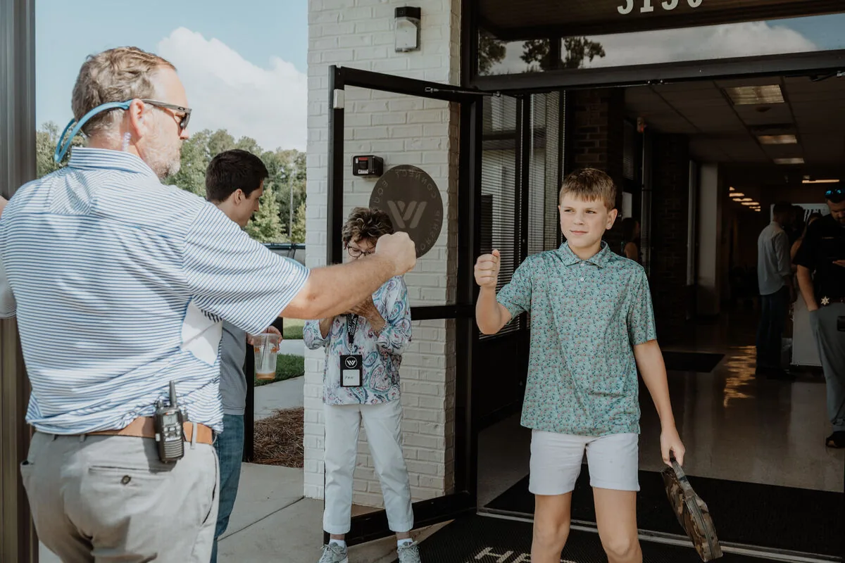 People being welcomed at the doors on the way in.