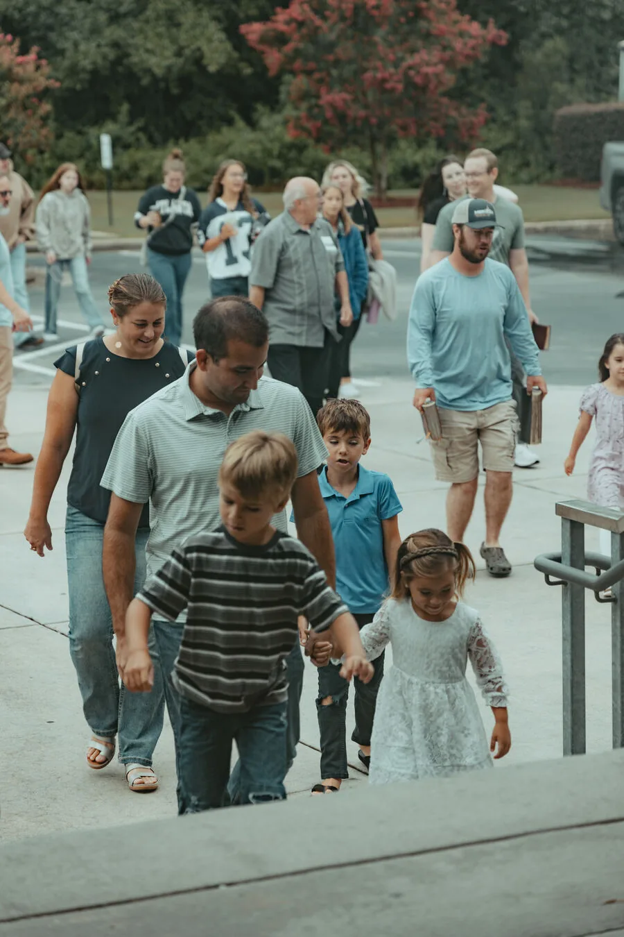 Families walking in from the parking lot.