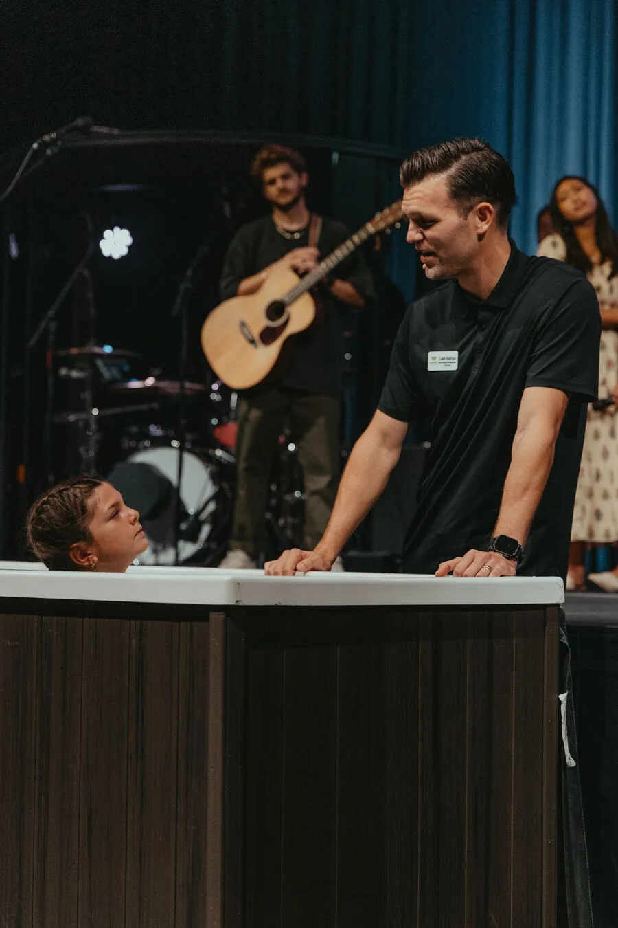 A baptism at the front of the room.