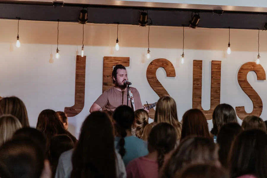A room of students in front of the stage.
