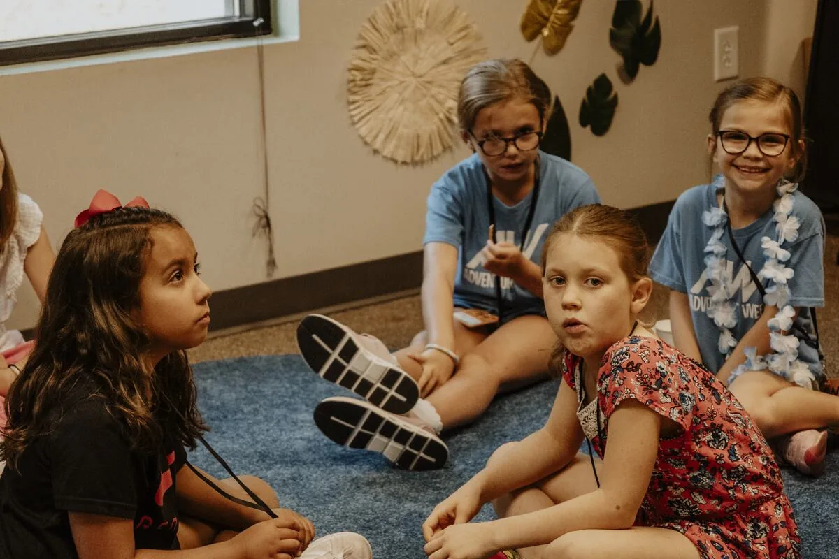 Children sitting together on the floor.