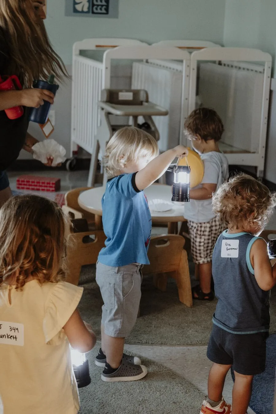 Young children playing with lanterns.