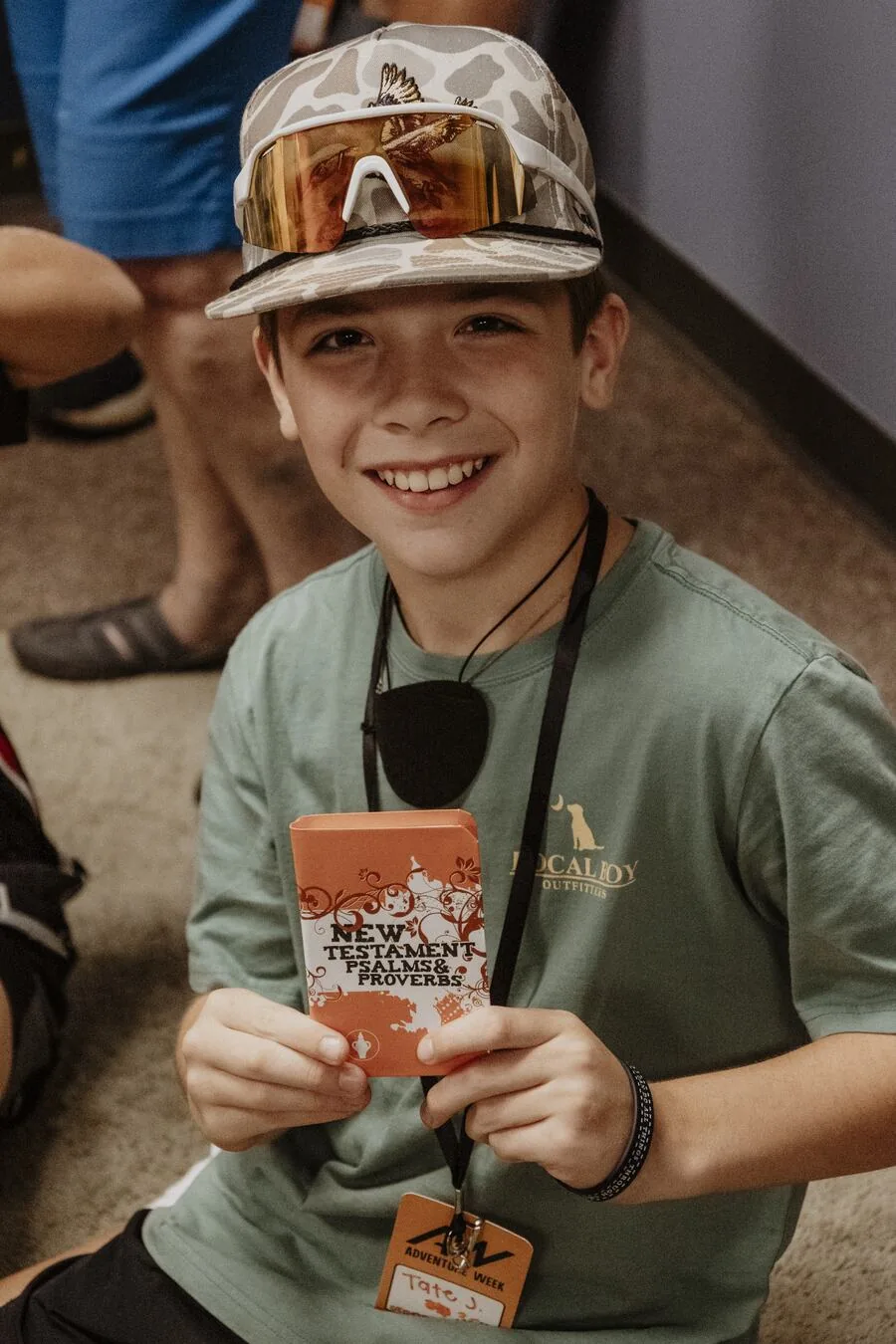 A child smiling in a name tag.