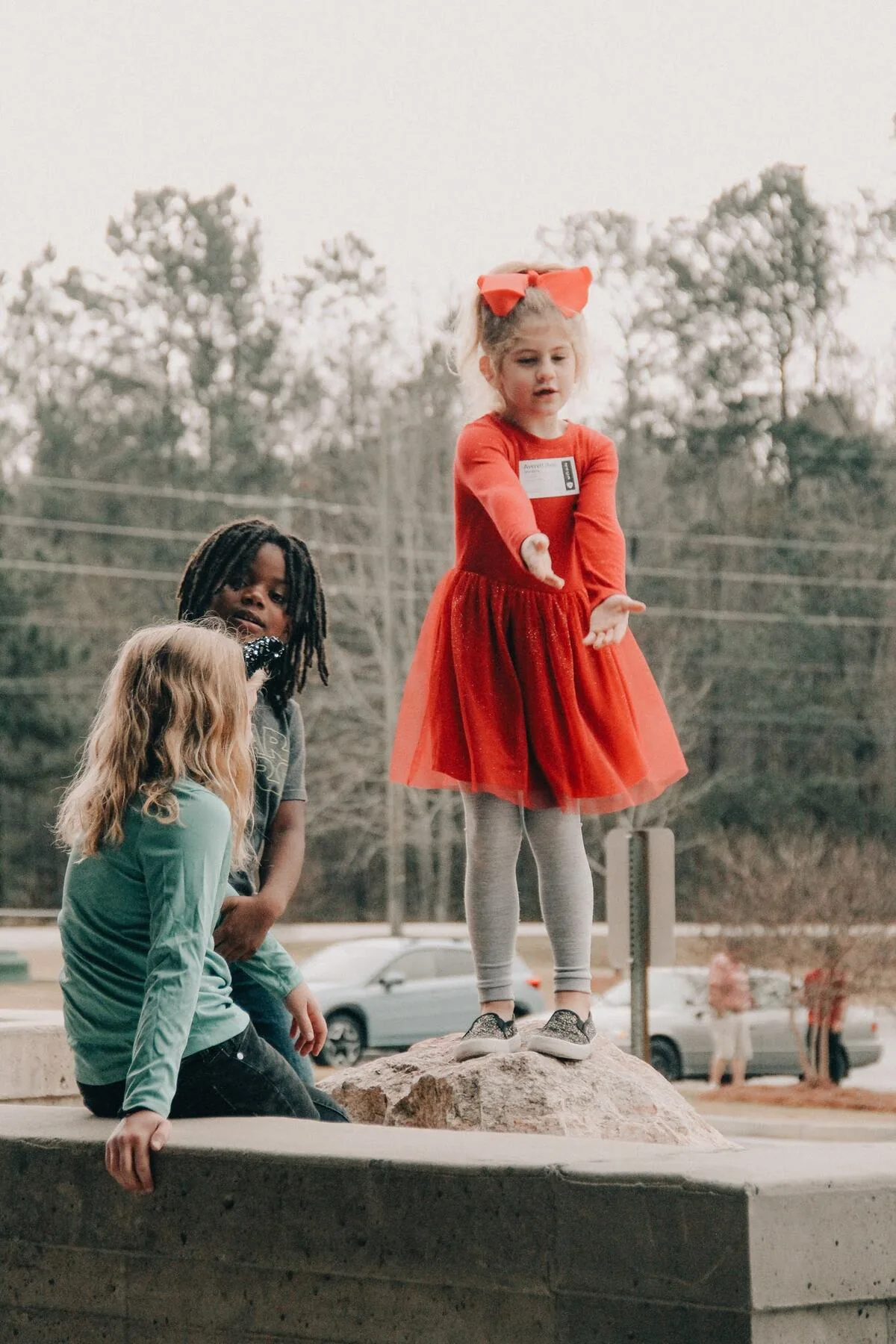 A child walking in hand in hand with an adult.