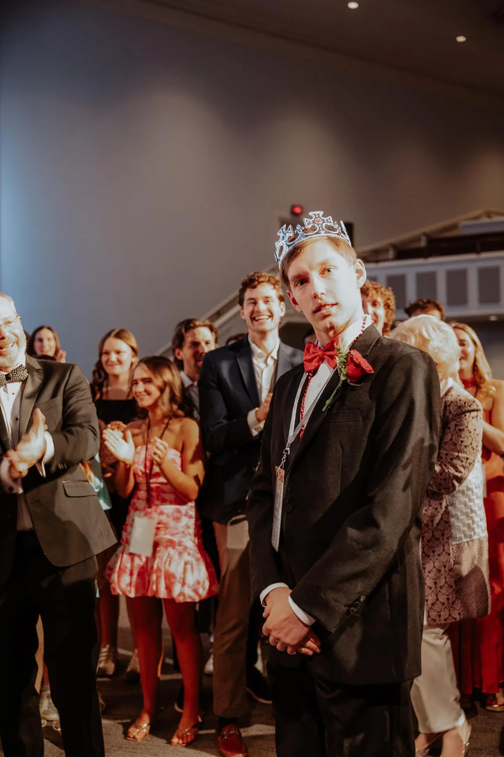 A crowned guest with the crowd around them.