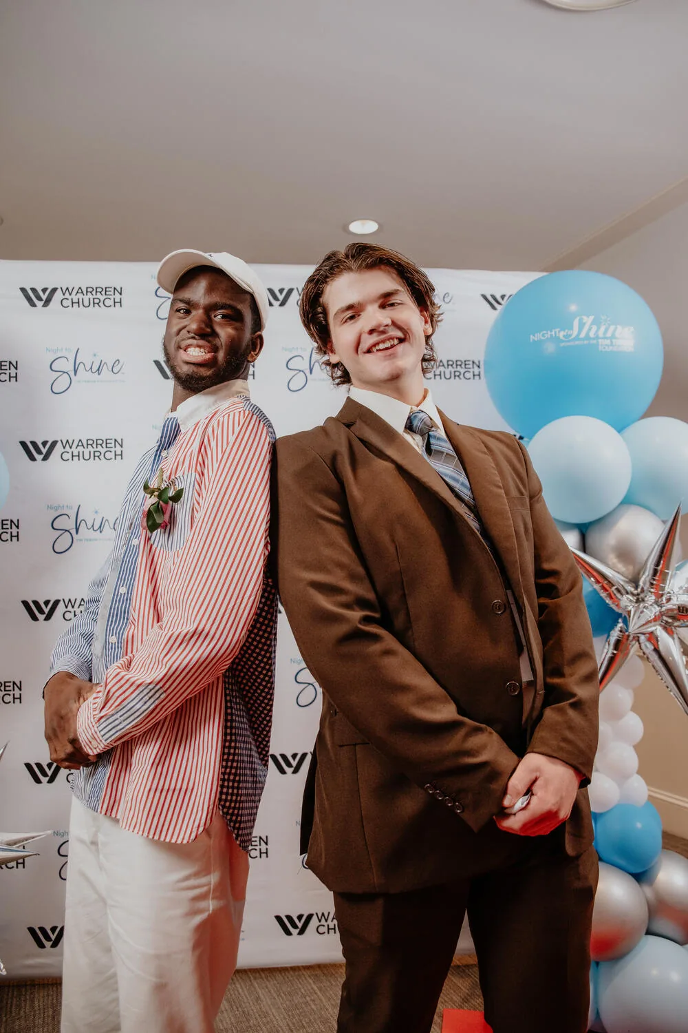 Two guests beside the balloons.