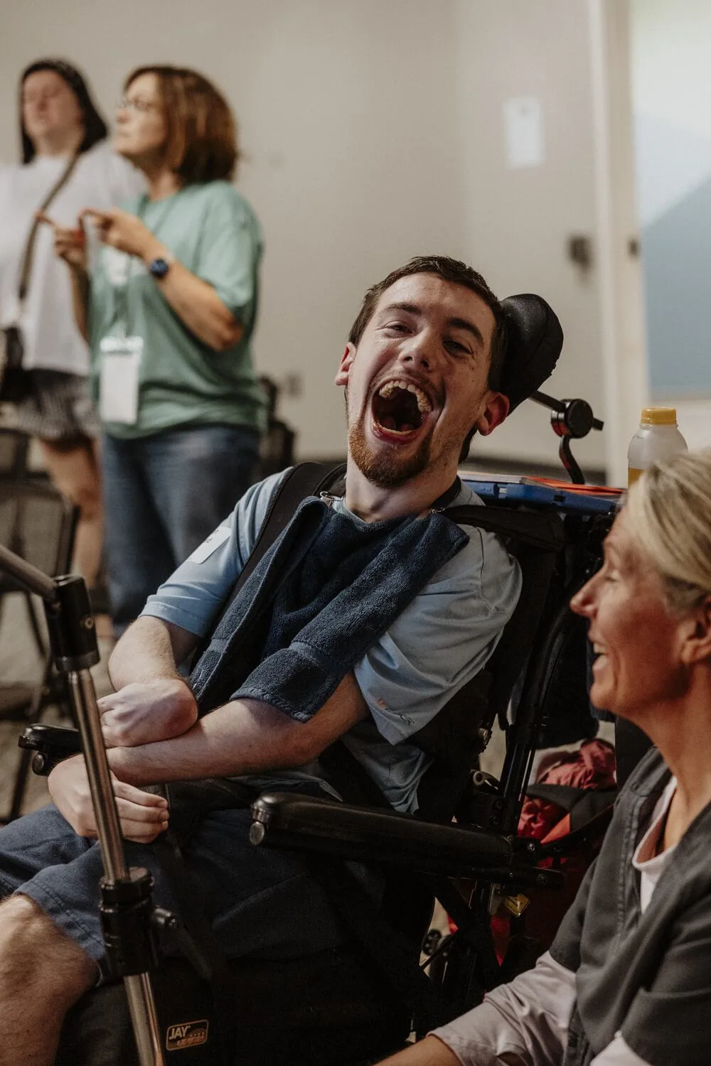 A participant laughing with a volunteer.