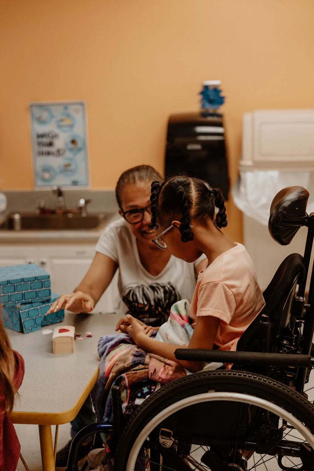 A volunteer helping at the activity table.