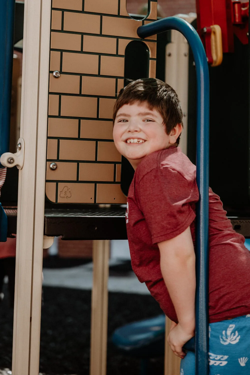 A boy on the playground equipment.
