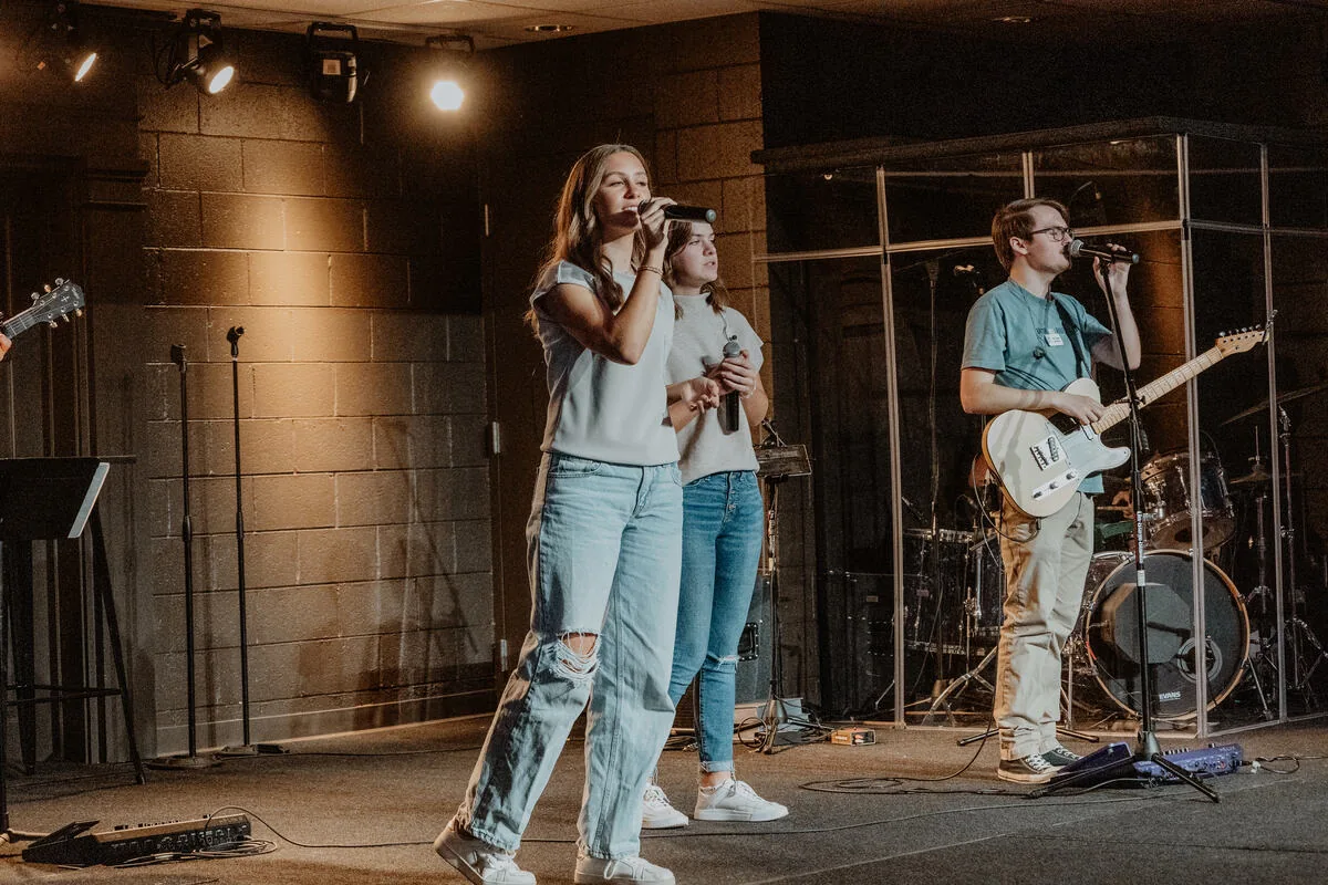 Leading a song from the stage.