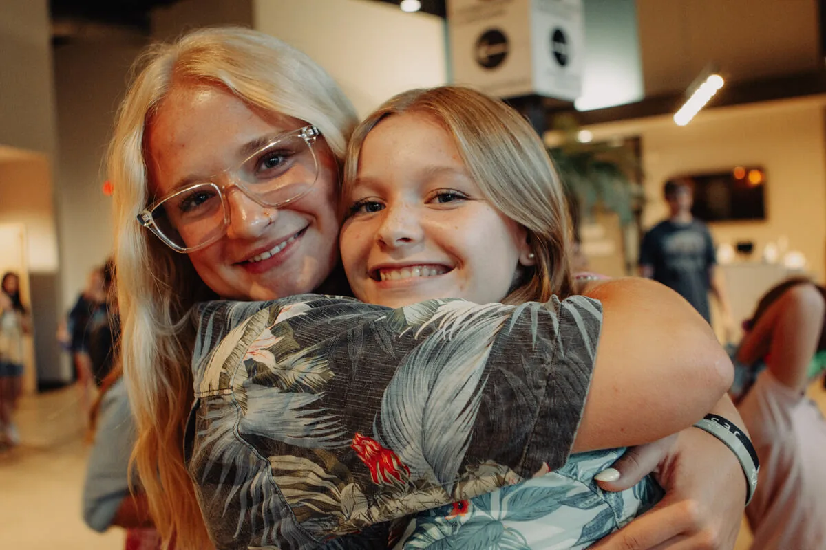 Two students hugging.