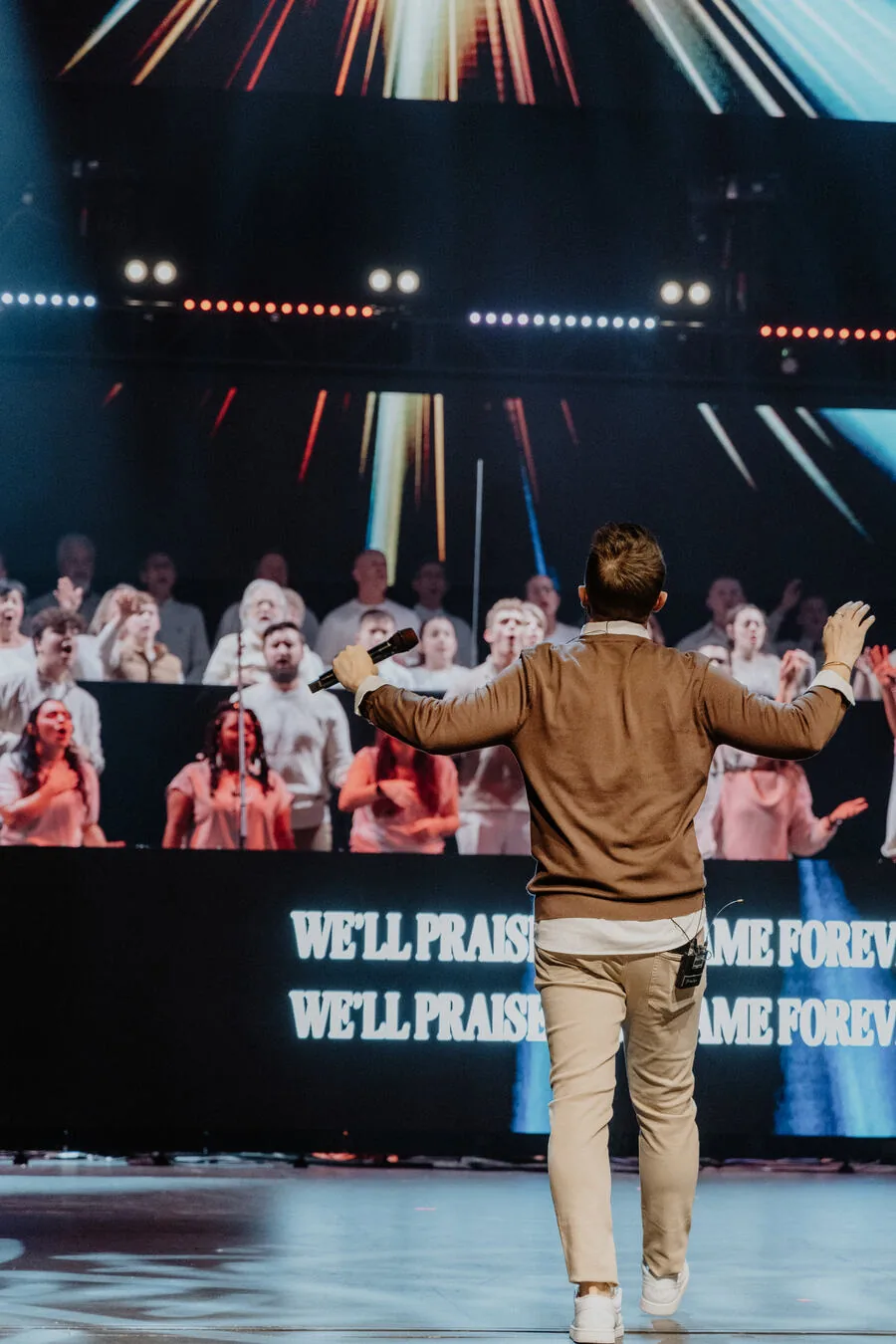 Leading the room from the front of the stage.