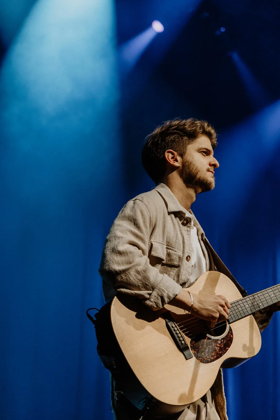 A guitarist singing lead.