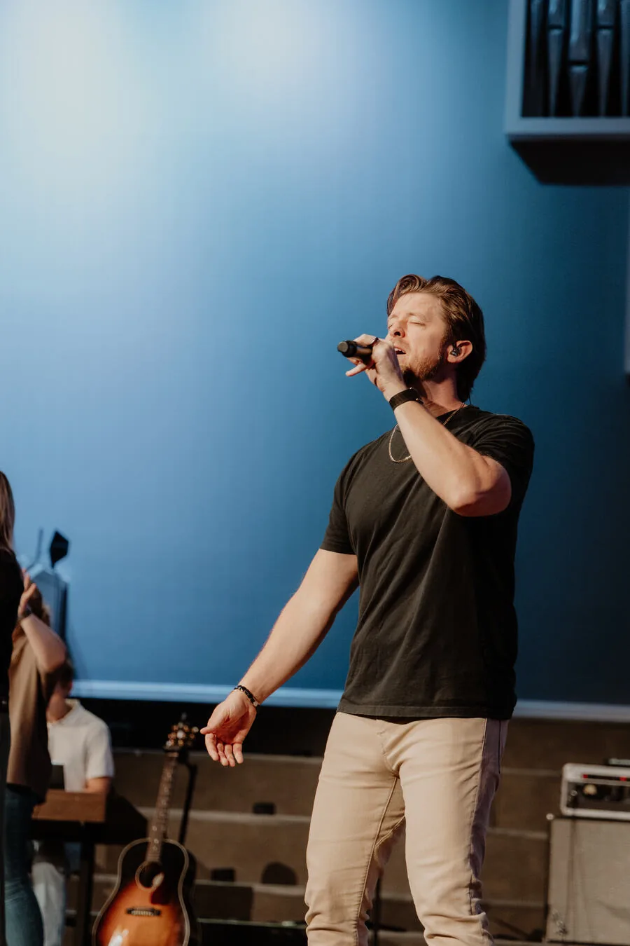 Singing into the microphone.