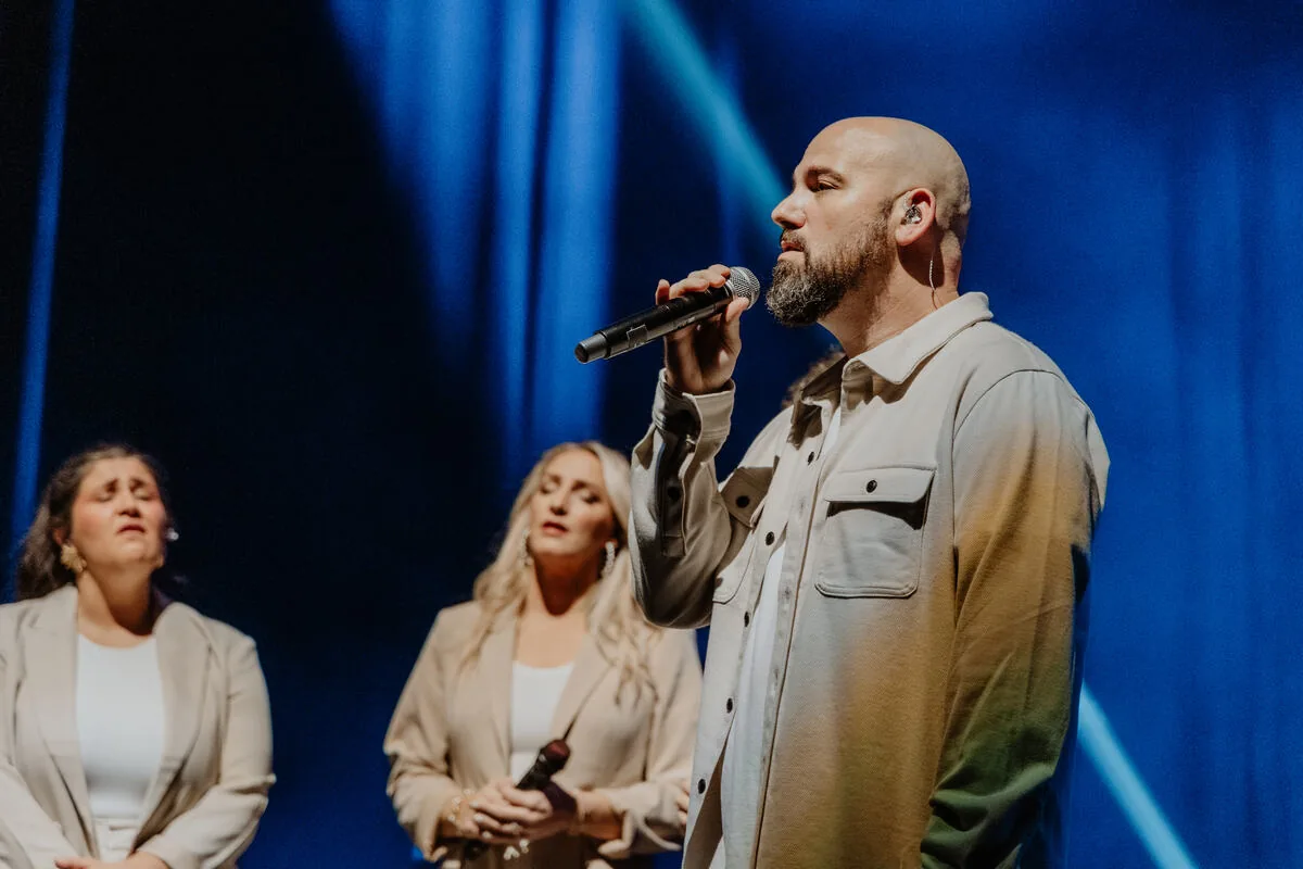 Leading a song with the vocal team behind.