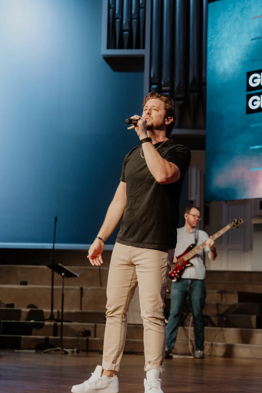 Singing with the band behind.