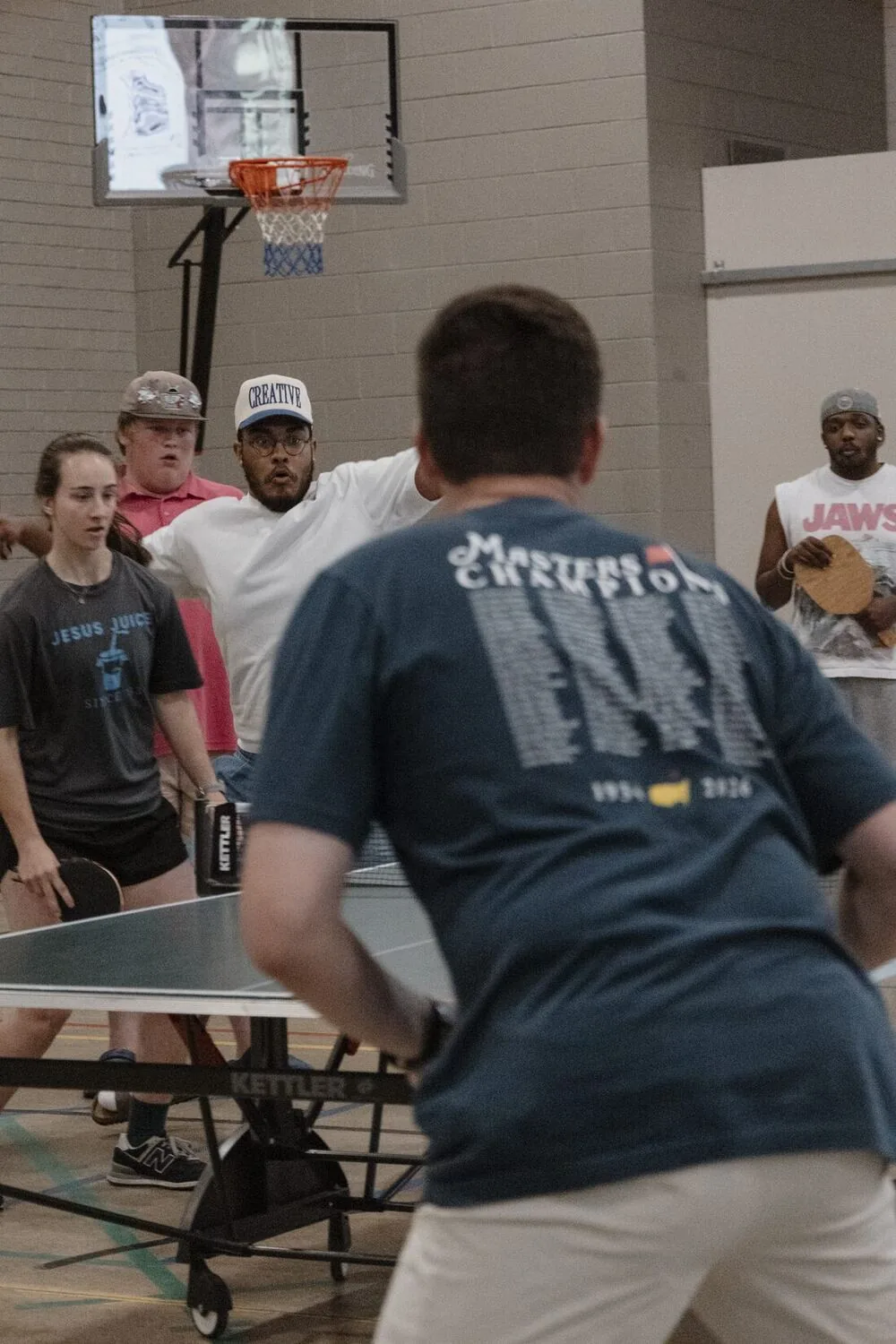 A game of table tennis in the gym.