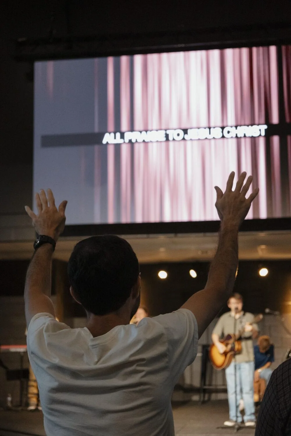 Hands raised during worship on a Sunday night.
